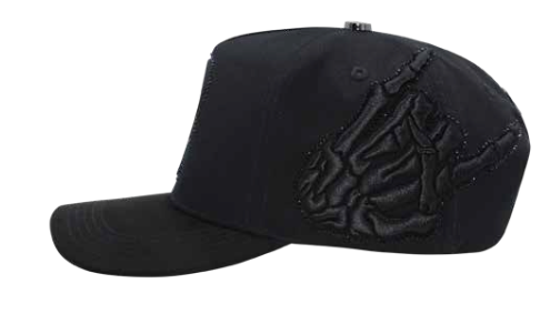 A black  cap featuring a prominent, raised black skeleton hand graphic on the side, shown against a plain white background.